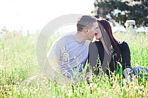A couple kissing in the meadow