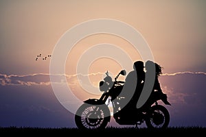 Couple kissing on motorbike