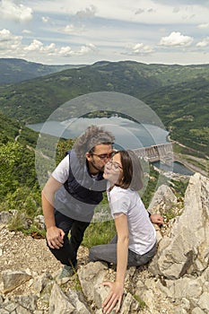Couple kissing at mountain viewpoint