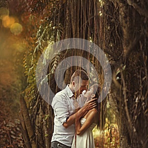 Couple kissing in mysterious forest