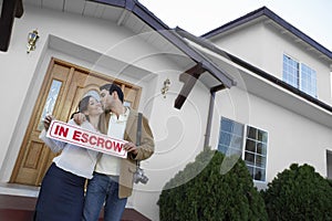 Couple Kissing Outside New House