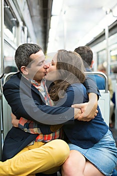 Couple kissing in Parisian metro