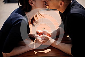 Couple kissing at restaurant table