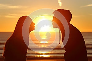 Couple kissing sun with love at sunset photo