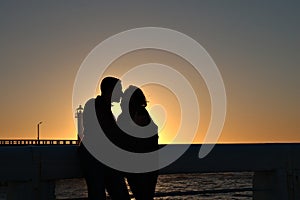 Couple kissing at sunset