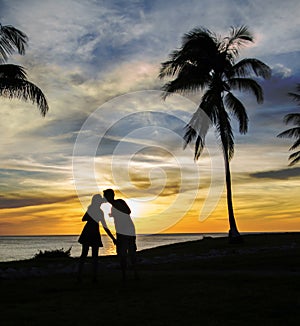 Couple kissing at sunset