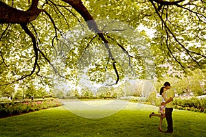 Couple kissing under tree