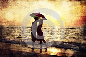 Couple kissing under umbrella at the beach in sunset. Photo in o