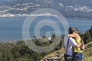 Couple kissing on vacation in Galicia, in front of MiÃ±o