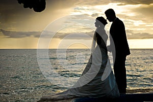 Couple kissing after a wedding at the beach
