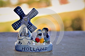 Couple kissing at the windmill in a small ceramic souvenir photo