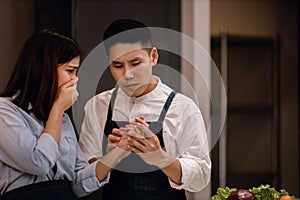 Couple in the Kitchen. Accident while Preparing Food