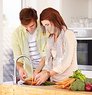 Couple, kitchen and vegetables for washing, sink and smile for food, nutrition and cooking together. Man, woman and