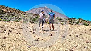 Couple on La Canada de los Guancheros dry desert plain with view on volcano Pico del Teide, Mount Teide National Park, Tenerife photo