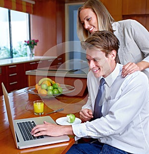 Couple, laptop and home with breakfast, online information and social network scroll with a smile. Marriage, computer