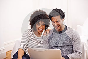 Couple, laptop and living room with technology, smile and love for home or house. Man, woman and lounge for internet