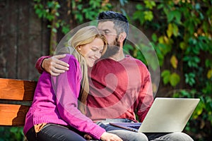 Couple with laptop sit bench in park nature background. Family surfing internet for interesting content. Internet