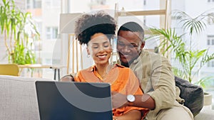 Couple, laptop and smile with hug in home living room, online browsing or web scrolling on sofa. Interracial, computer
