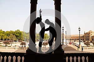 Couple of latin and bachata dancers dancing in a square. They are a young and handsome man and a beautiful woman. Dance concept