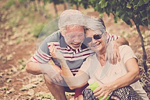 Couple laugh in happines together forever playing with soap bubbles in the country yard outdoor leisure activity. stay young