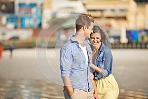 Couple, laugh and walk on beach for romantic date, jokes and bonding together on holiday in Italy. Happiness, boyfriend