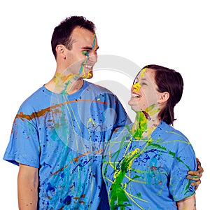 Couple laughing after having a paint fight