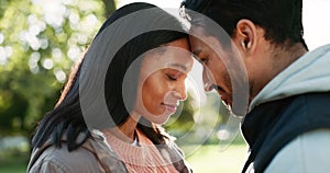 Couple, laughing and hug outdoor at a park in nature with love, care and commitment in marriage. Face of a young man and