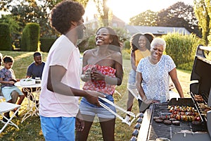 Couple laughing at a multi generation family barbecue