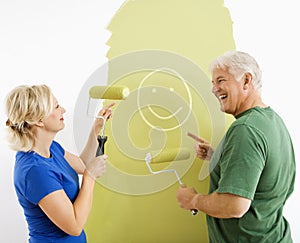 Couple laughing at smiley face painting.