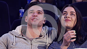 Couple laughs at the movie theater