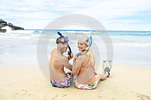 Couple lay on the beach is going to swim and snorkle on hawaii beach
