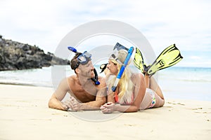 Couple lay on the beach is going to swim and snorkle on hawaii beach