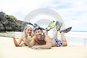 Couple lay on the beach is going to swim and snorkle on hawaii beach