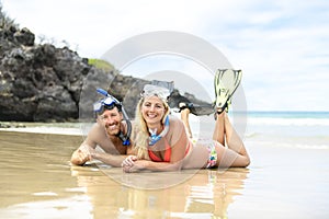 Couple lay on the beach is going to swim and snorkle on hawaii beach