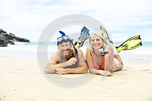 Couple lay on the beach is going to swim and snorkle on hawaii beach