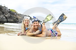 Couple lay on the beach is going to swim and snorkle on hawaii beach