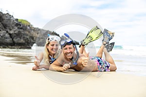 Couple lay on the beach is going to swim and snorkle on hawaii beach