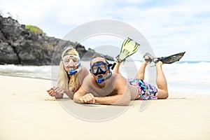 Couple lay on the beach is going to swim and snorkle on hawaii beach