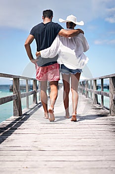 Couple legs, walking and beach deck on a tropical island on vacation with freedom by sea. Ocean, relax and walk of a man