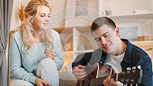 Couple leisure music home man guitar woman love