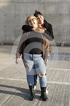 Couple of lesbian women hugging in a park