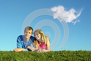 Couple lies on meadow with cloud photo