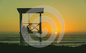 Couple lifeguard tower beach sunset