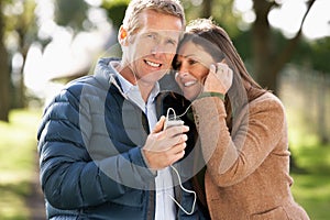 Couple Listening To MP3 Whilst Walking photo