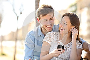 Couple listening to the music from a smart phone