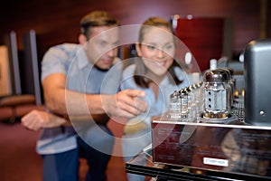 Couple listening to music through tube amplifier