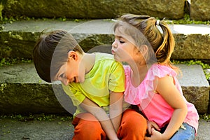 Couple of little children. Boy and girl. childhood first love. small girl and boy on stairs. Relations. summer holiday