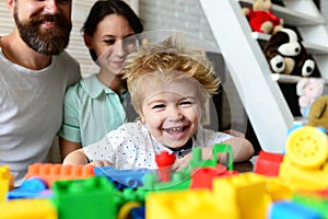 Couple in living room with baby smiling