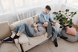 Couple in living room obsessed with smartphones