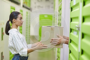 Couple Loading Boxes in Self Storage Unit Side View